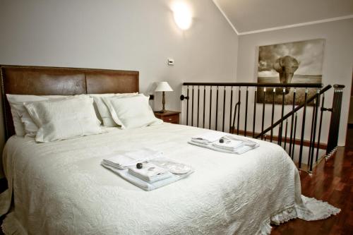 a bedroom with a bed with two trays on it at Borgo Manzoni - Charming House in Rozzano