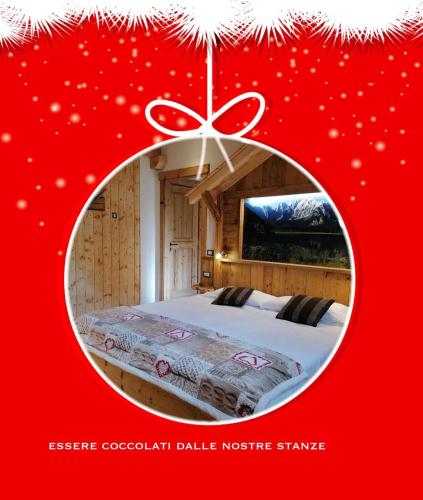 a christmas picture of a bedroom with a bed at Hotel La Baita in Malborghetto Valbruna