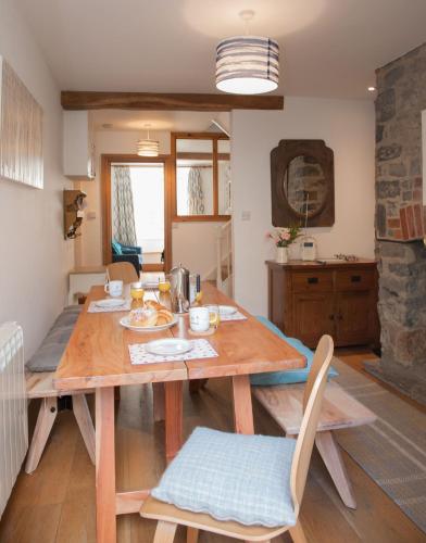 a wooden table in a kitchen with a dining room at Teal House in Lyme Regis