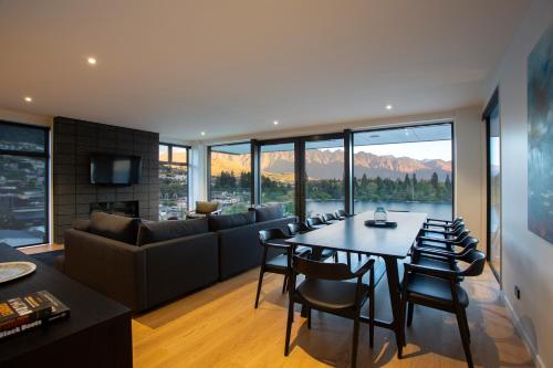 a living room with a table and a couch at Whakarire by Sotheby's Luxury Rental Homes in Queenstown