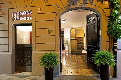 an entrance to a building with two potted plants at Boutique Hotel Anahi in Rome