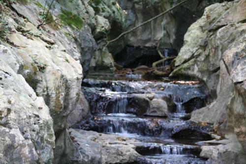 a small waterfall in a rocky canyon with rocks at Hotel Rural Bereau in Lesaka