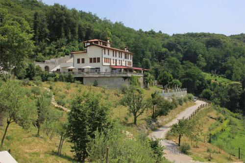 a house on the side of a hill with a road at Agriturismo Casa Adea in Rodengo Saiano