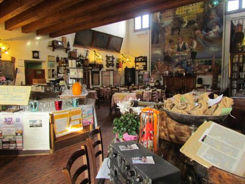 a store with tables and chairs in a room at Ristorante Alloggio Ostello Amolara in Adria
