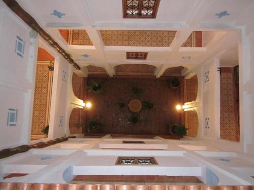 a large living room with a large room with a ceiling at Hôtel Ras El Maa in Chefchaouen