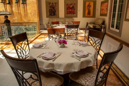 a dining room with a table with a white table cloth at The Lorian Club in Cocoyoc