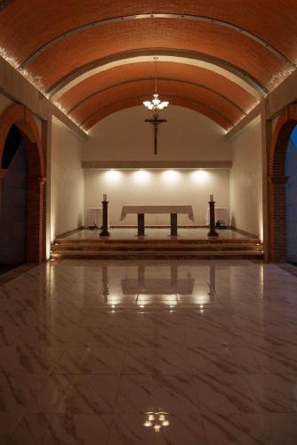 a large room with a altar and a bench in it at The Lorian Club in Cocoyoc