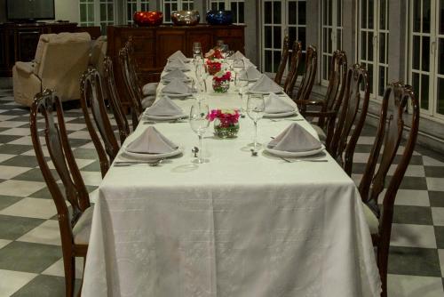 a long table with white table cloth and flowers on it at The Lorian Club in Cocoyoc