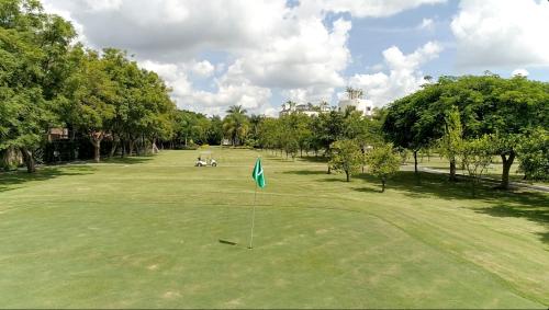 einen Golfplatz mit einer Flagge mitten im Grünen in der Unterkunft The Lorian Club in Cocoyoc