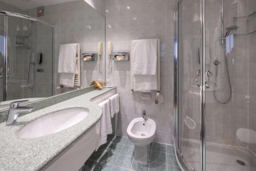 a bathroom with a sink and a shower and a toilet at Best Western Air Hotel Linate in Segrate