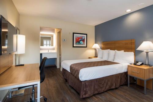 a hotel room with a large bed and a desk at SureStay Hotel by Best Western Fairfield Napa Valley in Fairfield