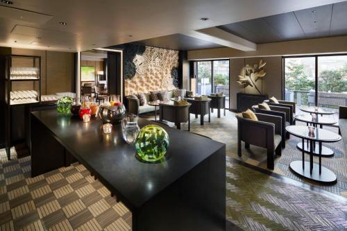 a lobby with a bar and tables and chairs at Grand Prince Hotel Shin Takanawa in Tokyo