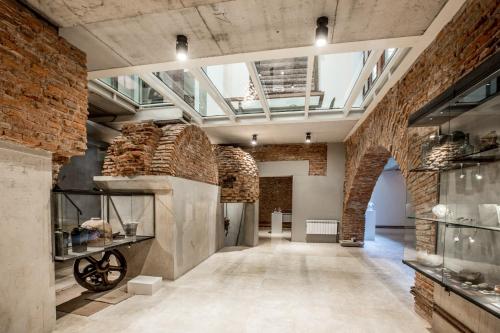 a large room with brick walls and a glass ceiling at Cassa Lepage Art Hotel Buenos Aires in Buenos Aires