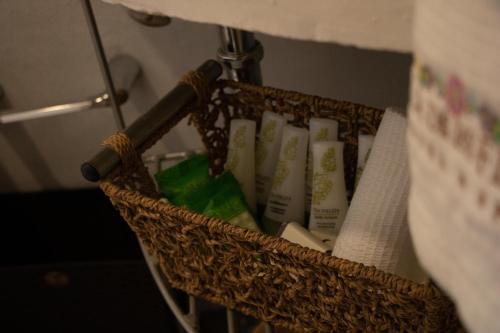 a basket filled with toothbrushes and a lamp at Casa Flores Hotel & Spa in Atlixco