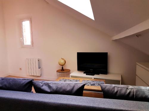 a living room with two couches and a flat screen tv at SW Cosy Apart - Chambly Persan Roissy in Persan