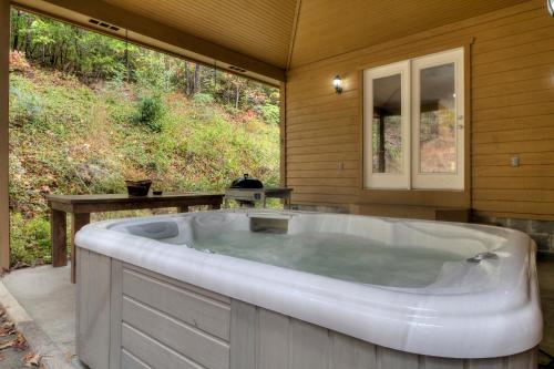 a large bath tub sitting inside of a house at 5Bedrooms*4KING BEDS*OUTSTANDING LOCATION*HotTub* in Sevierville