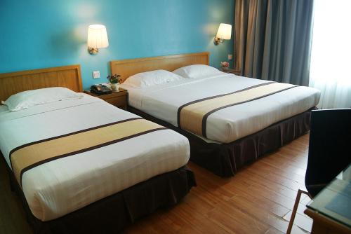 Postel nebo postele na pokoji v ubytování Tang Dynasty Bay Hotel