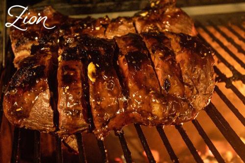 a piece of food is cooking on a grill at Zion Beach House in Cartagena de Indias