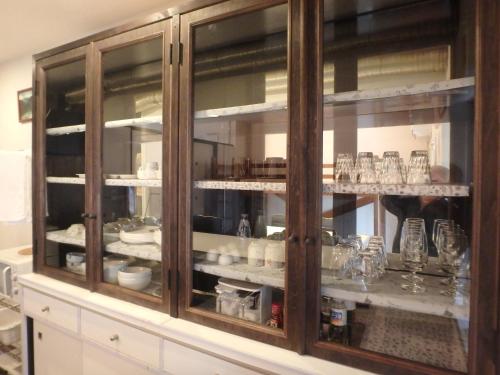 a cabinet filled with dishes and glasses on display at Kyo No Yado Nishioji inn in Kyoto