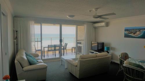 a living room with a view of the ocean at Pacific Surf Absolute Beachfront Apartments in Gold Coast