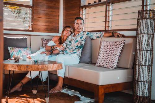 a man and a woman sitting on a couch at Halamanan Residences in Panglao