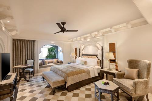 a bedroom with a bed and a living room at Aurika, Udaipur - Luxury by Lemon Tree Hotels in Udaipur