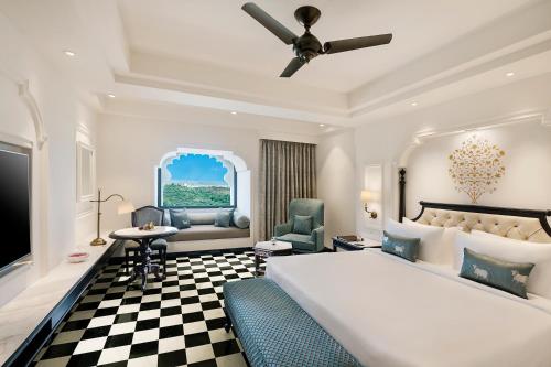 a bedroom with a large bed and a checkerboard floor at Aurika, Udaipur - Luxury by Lemon Tree Hotels in Udaipur