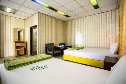 Postel nebo postele na pokoji v ubytování Bualuang HOTEL
