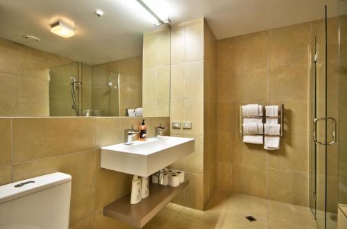 a bathroom with a sink and a shower at Lakes Edge Apartment in Queenstown
