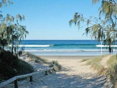 a beach with a wooden path leading to the ocean at Malibu Apartment - Peregian Beach in Peregian Beach
