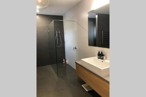 a bathroom with a sink and a shower at Malibu Apartment - Peregian Beach in Peregian Beach