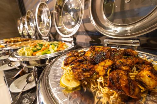 a buffet with several plates of food on a table at After Hours Residence in Dhaka