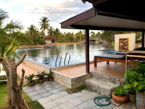 a swimming pool with a bench and a table at Rock Garden E28 4 bedroom Pool villa in Mae Pim