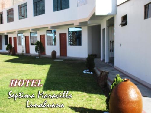 an orange sitting in front of a building at Hotel Septima Maravilla Lunahuana in Lunahuaná