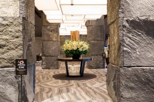 a vase of flowers on a table in a hallway at KensingtonResort JirisanHadong in Hadong