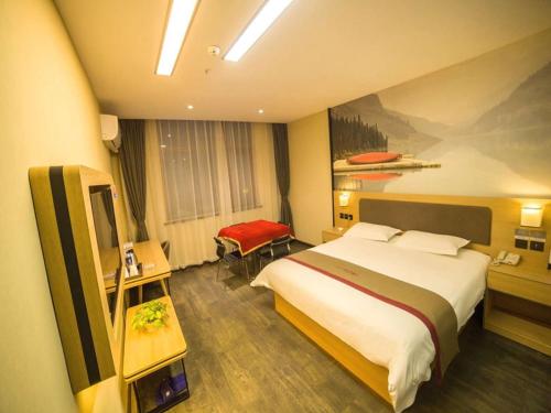 a hotel room with a large bed and a desk at Thank Inn Plus Hotel Hebei Cangzhou Botou Jinji Logistic Park in Cangzhou
