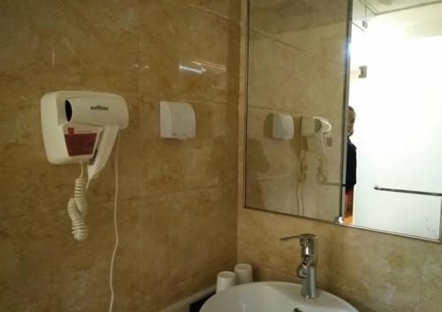 a bathroom with a sink and a mirror at Thank Inn Plus Hotel Shanxi Yanan Ganquan County North Railway Station in Yan'an
