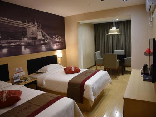 a hotel room with two beds and a dining room at Thank Inn Plus Hotel Chongqing Wanzhou District Pedestrian Street in Wanxian