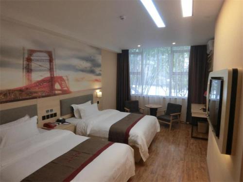 a hotel room with two beds and a flat screen tv at Thank Inn Plus Hotel Guangxi Liuzhou Donghuan Road Hualinjundi in Liuzhou