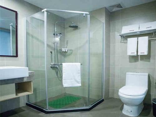 a bathroom with a shower with a toilet and a sink at Up And In Yunnan Dehongzhou Mangshi Street in Mangshi