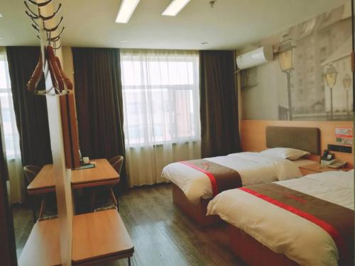 a hotel room with two beds and a desk at Thank Inn Plus Hotel Hebei Baoding Lixian County Liwu Street in Baoding