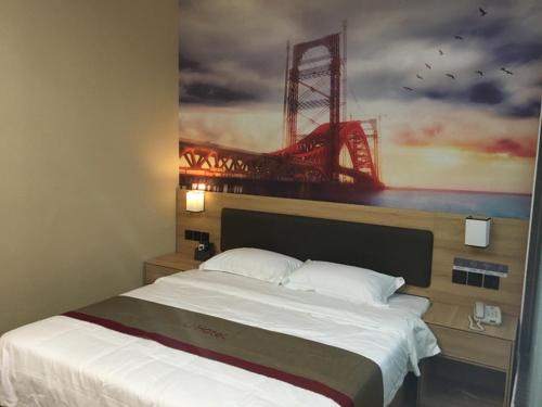 a bedroom with a bed with a painting of a bridge at Thank Inn Plus Hotel Jiangsu Suzhou Kunshan Dianshan Lake Town Xiangxinjiayuan in Suzhou