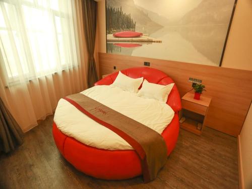 a bedroom with a large red bed in a room at Thank Inn Plus Hotel Hebei Xingtai Guangzong County North Outer Ring Road in Xingtai
