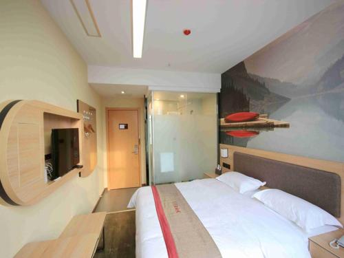 a bedroom with a large bed and a tv at Thank Inn Plus Hotel Hebei Handan Hanshan District Fu Southeast Street in Handan