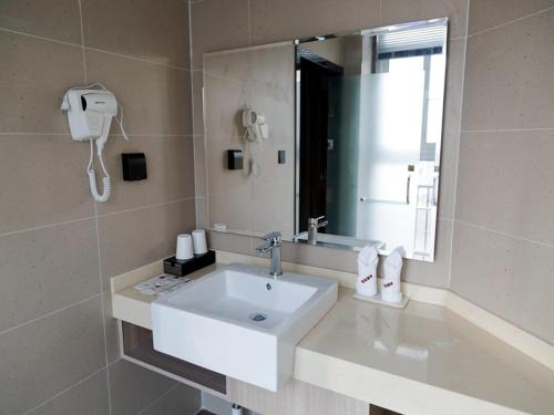 a bathroom with a white sink and a mirror at Up And In Anhui Chizhou Guichi DistrictAnhui University of Engineering in Chizhou