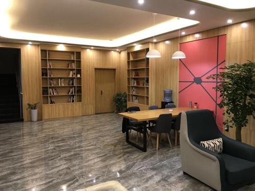 una oficina con mesa, sillas y estanterías en Thank Inn Plus Hotel Anhui Huibei Xiangshan District Suixi Middle Road en Huaibei