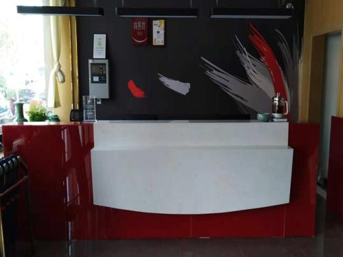 a red and white counter in a restaurant at Thank Inn Plus Hotel Henan Kaifeng Tongxu county Renmin Road in Kaifeng
