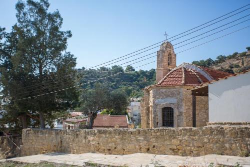 an old stone building with a tower and a church at Penthouse Duplex overlooking the Mediterranean in Larnaka