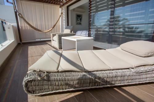 a wicker bed in a room with a window at Penthouse Duplex overlooking the Mediterranean in Larnaka