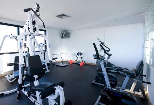a gym with several tread machines in a room at Airport Business Flat Guarulhos - São Paulo in Guarulhos